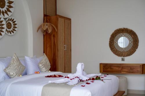 a bedroom with a bed with a bunny on it at The Alvarendra Ubud Villa By Bali Cabin in Ubud