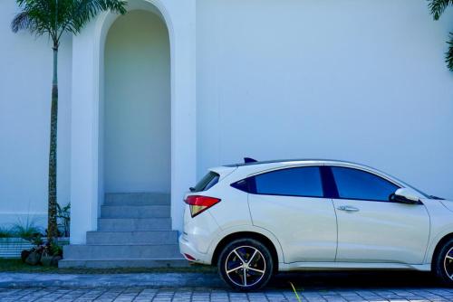 a white car parked in front of a building at The Alvarendra Ubud Villa By Bali Cabin in Ubud