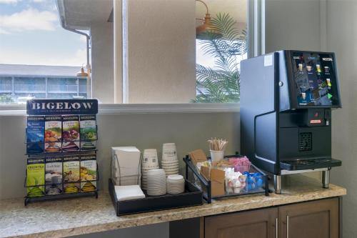 a kitchen counter with a refrigerator on a counter at Best Western Plus Jekyll Island in Jekyll Island