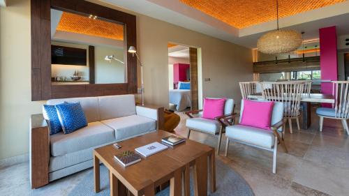 a living room with a couch and chairs and a table at Hotel Xcaret Mexico All Parks All Fun Inclusive in Playa del Carmen
