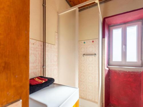 a bathroom with a red door and a window at Cevennes Stone Retreat in Saint-Germain-de-Calberte