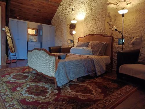a bedroom with a bed and a couch at Holiday Home in Teilhet near Chateau Rocher in Teilhet