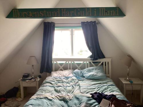 a bedroom with a bed in front of a window at 4 star holiday home in Humlebæk in Humlebæk