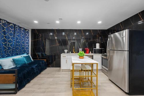 a kitchen with a refrigerator and a table and a couch at Bright and Airy 2BR with King Bed Free Parking and Pool in Houston