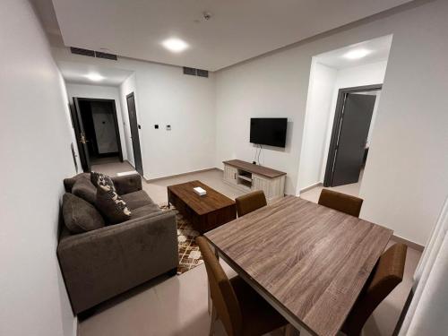a living room with a couch and a table at Aryaf Hotel Apart Tabasum Group in Ajman 