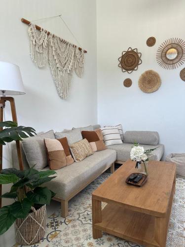 a living room with a couch and a coffee table at BlueDomeHouse Lt 1 in Kanggraksan