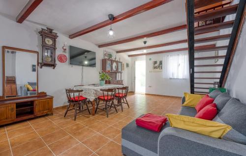 a living room with a couch and a table at 2 Bedroom Beautiful Apartment In Veli Losinj in Veli Lošinj