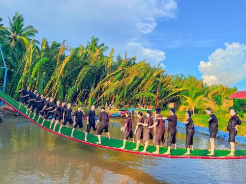 a group of people on a boat in the water at Du lịch Hạ Thảo Bến Tre in Ben Tre