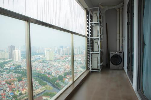 an empty room with large windows in a city at TSQ STAY Hotel Apartment in Hanoi