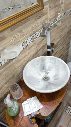 a bathroom with a white sink and a mirror at Flor de Lis in Puerto Iguazú