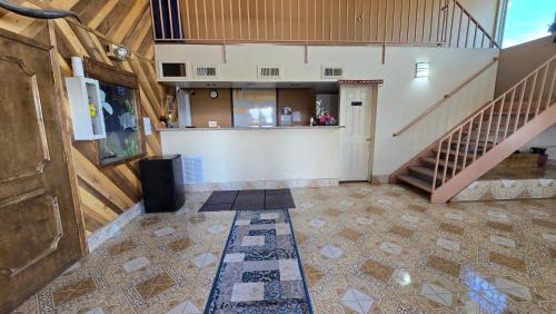 an empty room with a staircase and a lobby at Texan Inn and Suites Monahans in Monahans