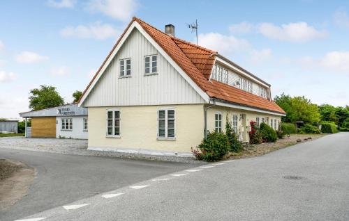 a white house with an orange roof on the side of a road at Gorgeous Home In Sydals With Wifi in Østerby