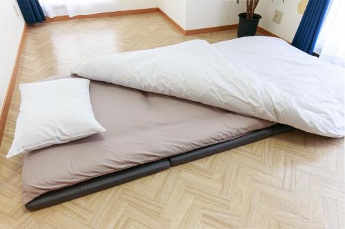 two beds sitting on the floor in a room at NT Building in Nagoya