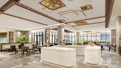 a lobby of a hotel with tables and chairs at Hilton Garden Inn Guiyang Gui'An New Area in Guiyang