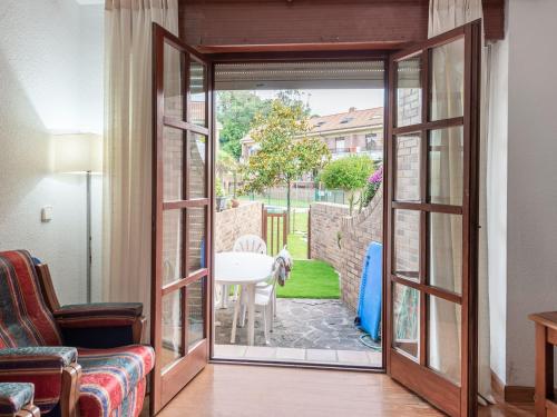 a living room with a door open to a patio at Holiday Home in Loredo near Surf Beach in Loredo
