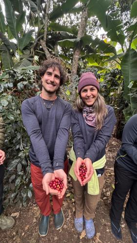 a man and woman holding picked fruit in their hands at Lia B&B Lucmabamba in Sahuayacu