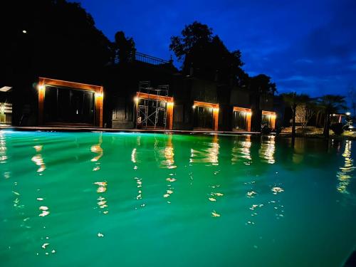 a swimming pool at night with green illumination at Sky country resort at khanom in Khanom