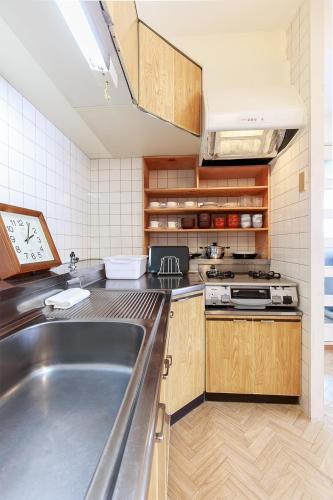 a kitchen with a large stainless steel sink at NT Building in Nagoya