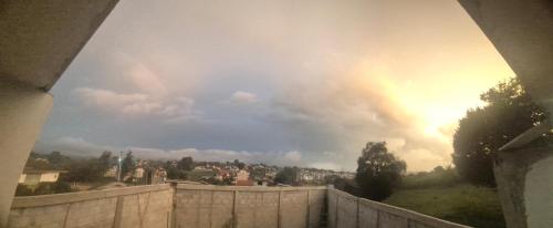 a rainbow in the sky over a city at Casa vacacional en zacatlan puebla in Zacatlán