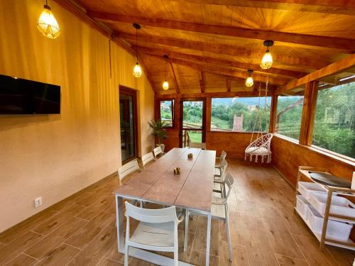 a large dining room with a large table and chairs at Vila Eden Pestera in Peştera