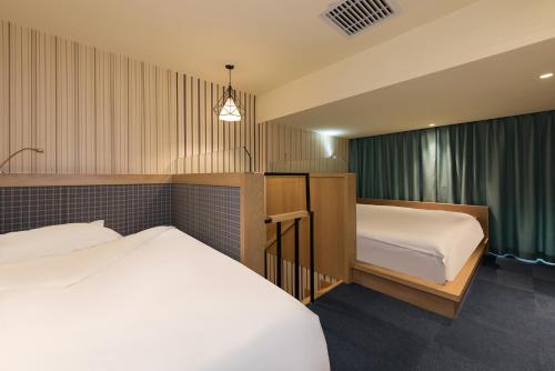 a hotel room with two beds and a window at Baihua Hotel in Beijing
