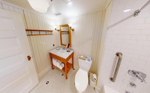 a bathroom with a toilet and a sink and a mirror at The Red Lion Inn in Stockbridge