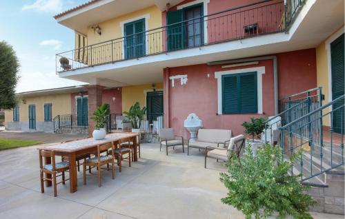 a patio with a table and chairs and a building at Villa Angela Holiday Apartment in Angri