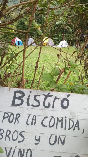 a sign for a biesta for a corona in a field at Cura Hostel Bistró in Villa Restrepo