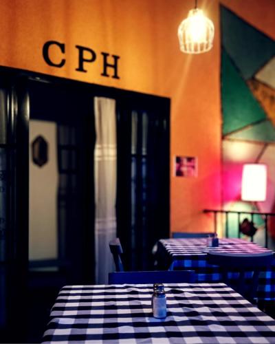 a restaurant with two tables and a checkered table cloth at Cura Hostel Bistró in Villa Restrepo