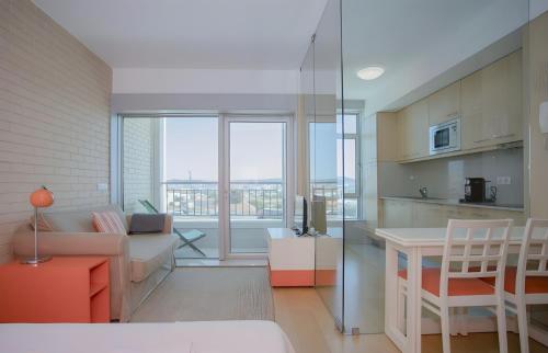 a living room with a couch and a table at Oporto Blue Dragão - Modern Uptown Studio With Free Parking in Porto