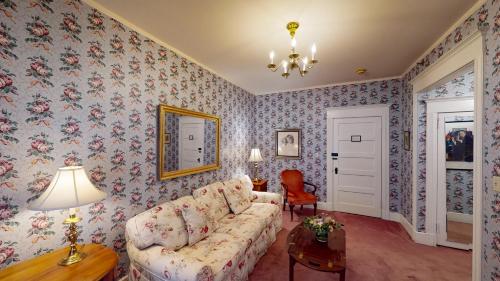 a living room with a couch and floral wallpaper at The Red Lion Inn in Stockbridge