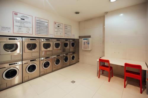 a laundry room with a row of washers and dryers at Oporto Blue Dragão - Modern Uptown Studio With Free Parking in Porto
