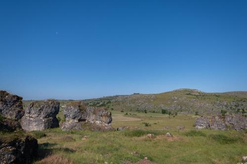 a group of large rocks in a field at Le p'tit pelet in Fraissinet-de-Fourques