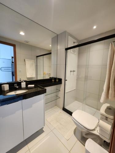 a bathroom with a shower and a toilet and a sink at Conforto e Tranquilidade em Muro Alto Malia 204B in Ipojuca