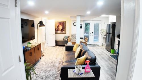 a living room with a couch and a table at 2 Bedroom Walkout Basement Ajax in Ajax