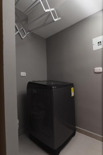 a room with a large black tv in a room at Encanto 16 - Apartamento moderno y lujoso in Ibagué