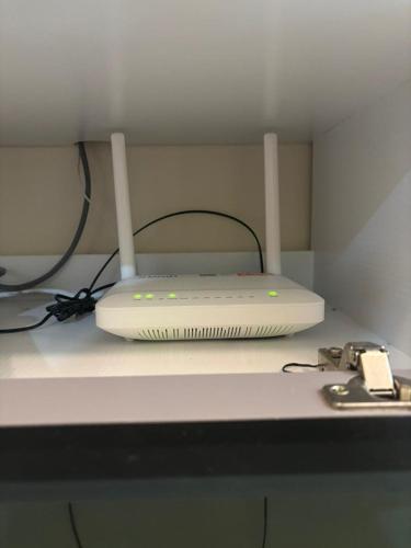 a laptop computer sitting on top of a desk at Nameera Stay Bandar Universiti Seri Iskandar in Seri Iskandar