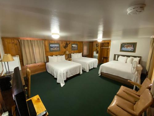a hotel room with two beds and a couch at Trails end motel in Dubois