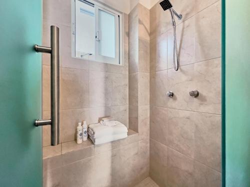 a bathroom with a shower with a glass door at Vallarta Luxuries in Mezcales