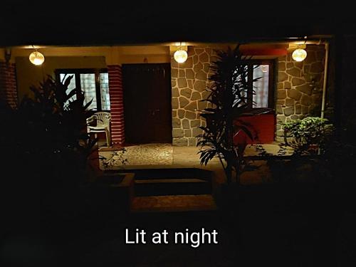 a house with a porch with a light at night at Nivaant at Vicharays Plus in Revadanda