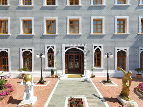 a building with two statues in front of it at A for Art Hotel in Limenas