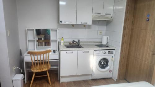 a kitchen with a washing machine and a sink at Kiman09 in Seoul