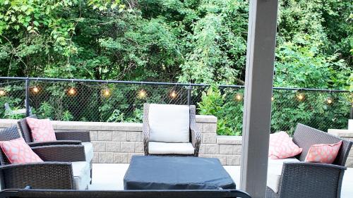a patio with chairs and a table and lights at 2 Bedroom Walkout Basement Ajax in Ajax