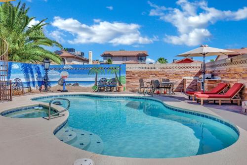 a swimming pool with a table and chairs next to it at Villa Juan BR Private Entry Pool Spa BBQ Free Parking in Las Vegas