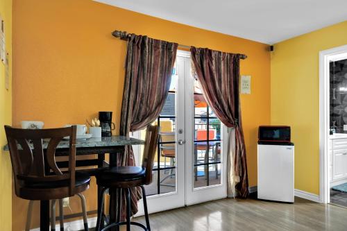 a dining room with a table and a door to a balcony at Villa Juan BR Private Entry Pool Spa BBQ Free Parking in Las Vegas