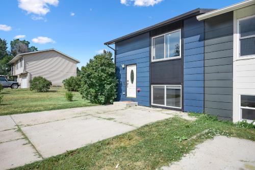 a blue house with a white door at Family Friendly Find on Emerson! in Gillette