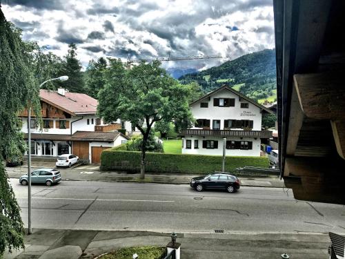 a view of a street with cars parked on the road at Gästehaus Brigitte in Garmisch-Partenkirchen