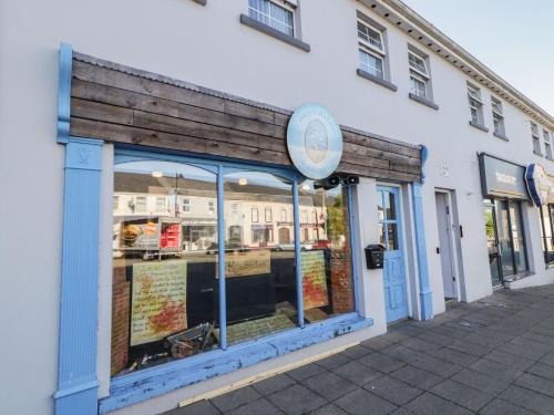 a store window with a sign on the side of a building at Shalom Apartment 98B in Armagh