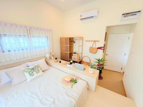 a living room with a white couch in a room at Nordika Hill in Pak Chong