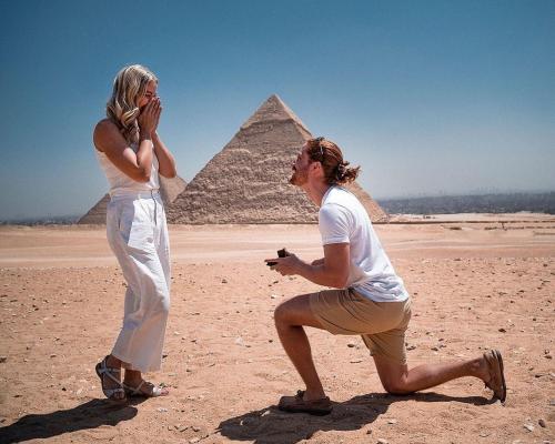 a man and a woman standing in front of the pyramids at Master Kings of the pyramids and Sphinx in Giza